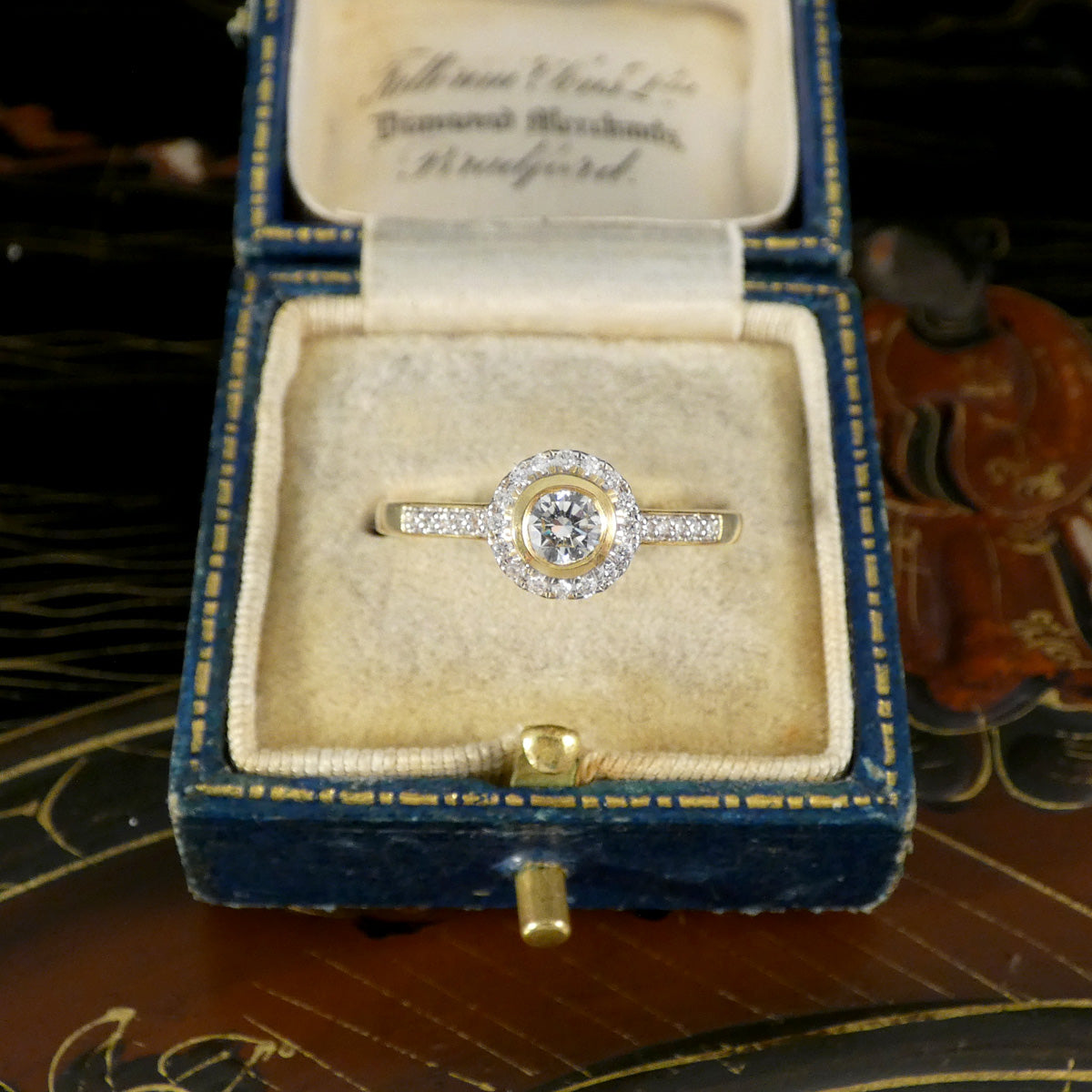 A gorgeous diamond engagement ring displayed in a vintage box.