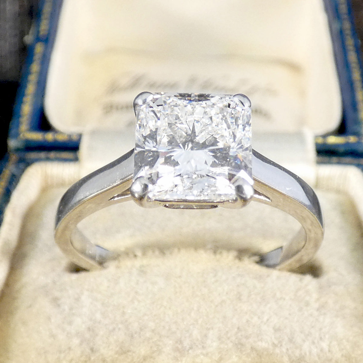 Diamond ring with a square cut cornered GIA certed diamond gemstone in a jewellery box