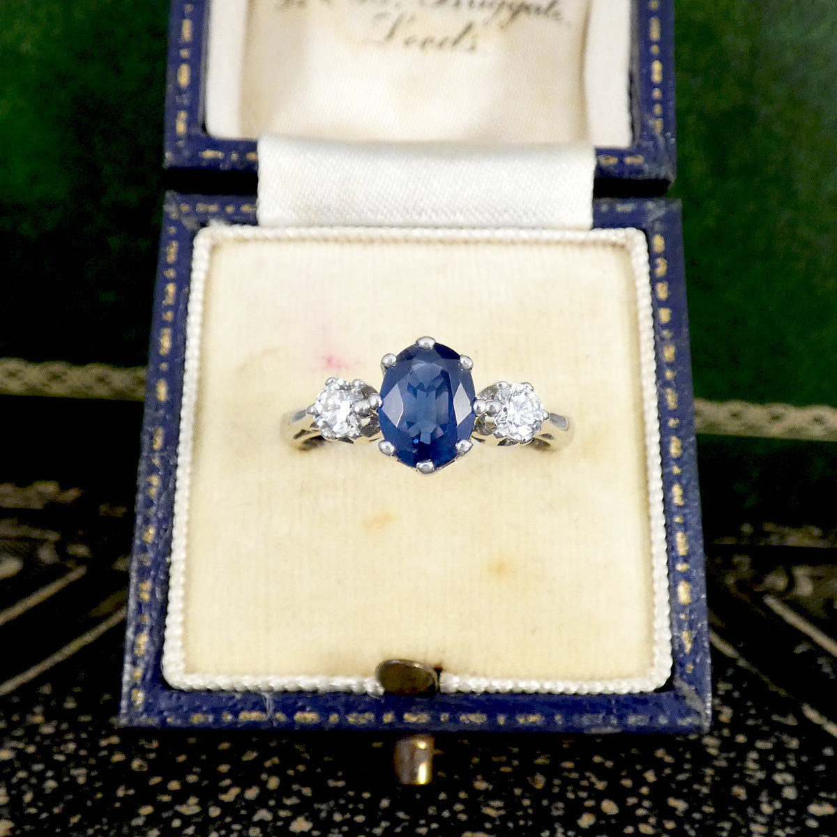 Blue gemstone ring with diamonds in a vintage box