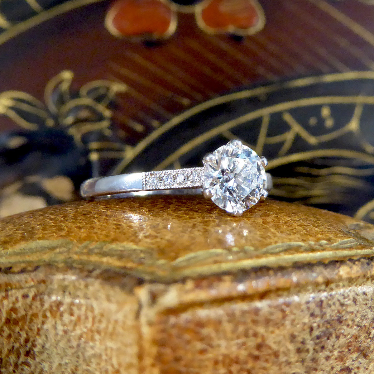 Diamond ring on an ornate wooden box with a blurred background