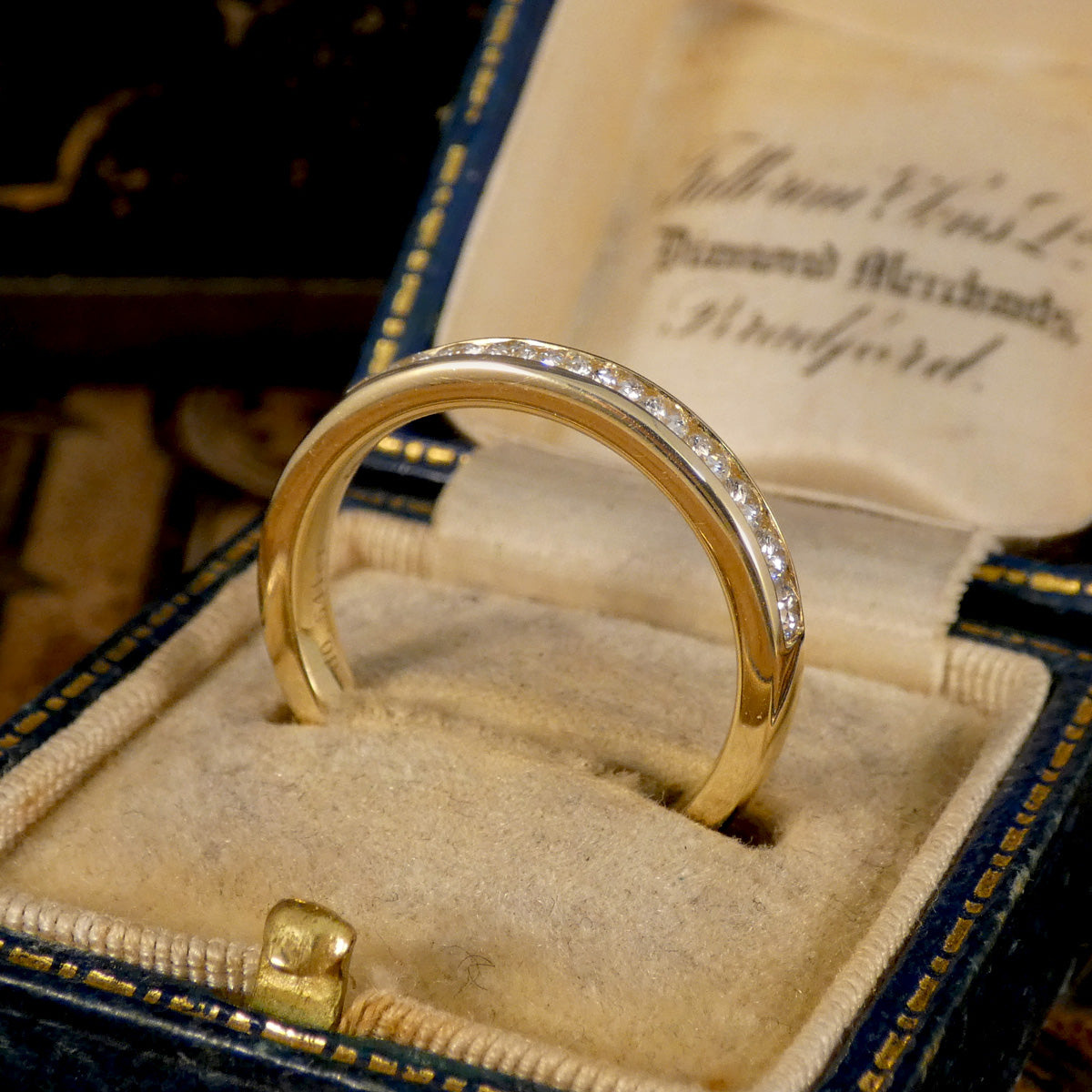 Channel Set 0.54ct Brilliant Cut Diamond Half Eternity Ring modelled in 9ct yellow gold for durability. Side view of low setting for safety of stones.