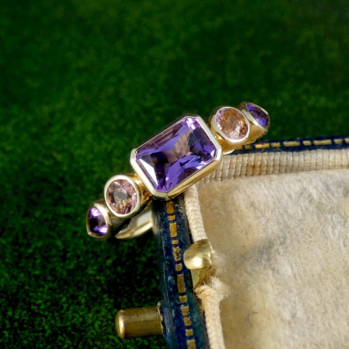 A gorgeous bright and beautiful Amethyst and Pink Tourmaline five stone ring in 9ct yellow gold with bezel settings.