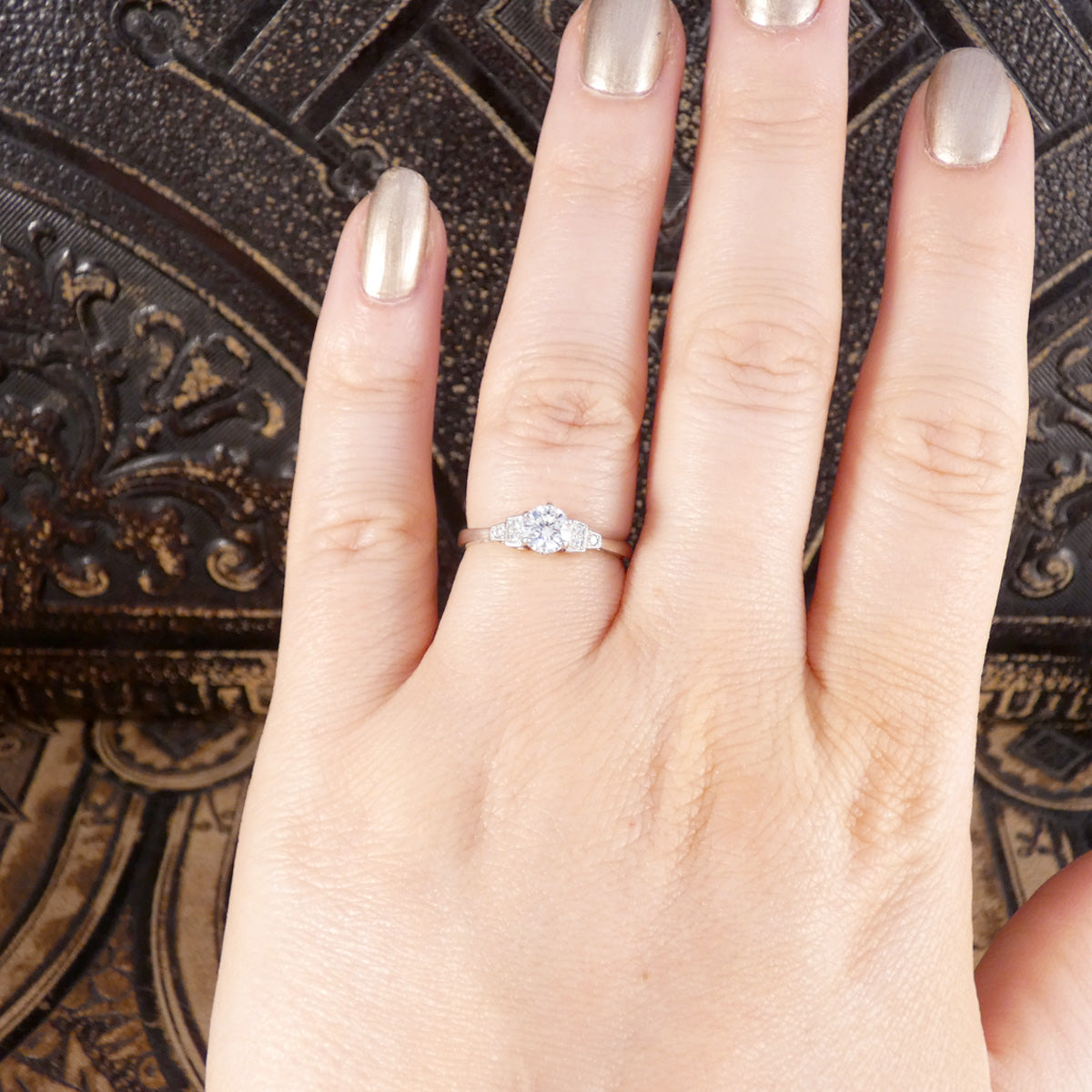 High colour and GIA cert diamond engagement ring shown worn on the finger.
