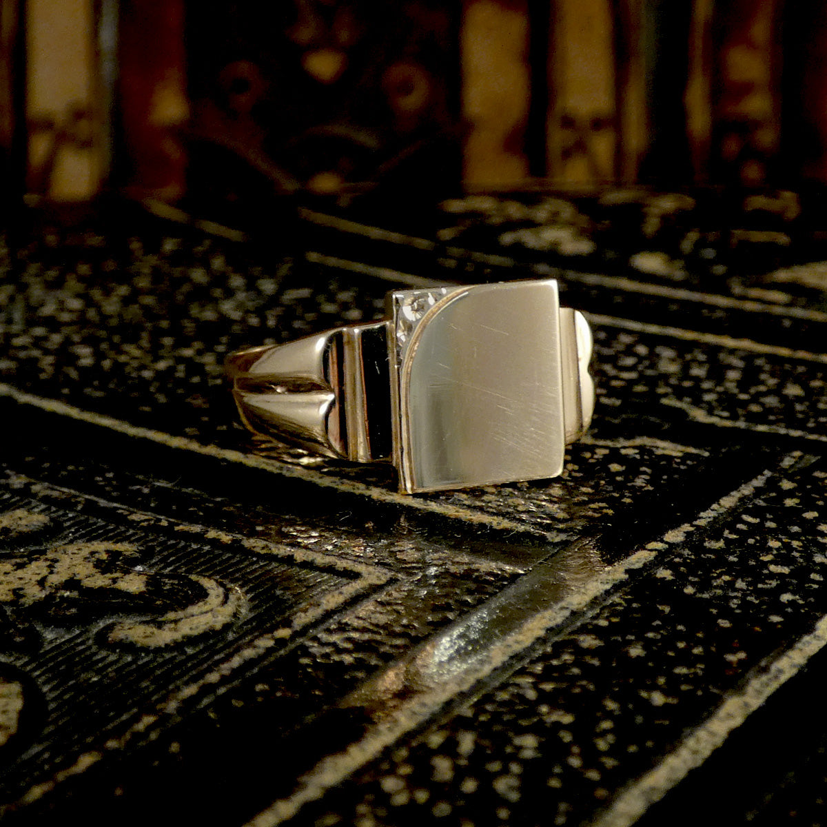 Gold ring on a textured surface with a warm-toned background