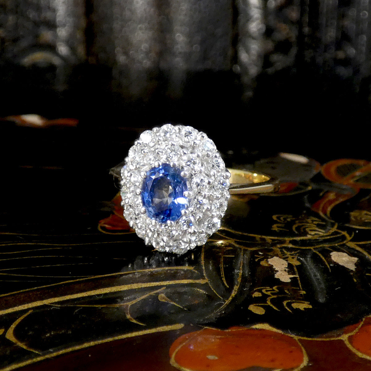 Vintage-style blue sapphire and diamond cluster ring set in 18ct yellow gold.