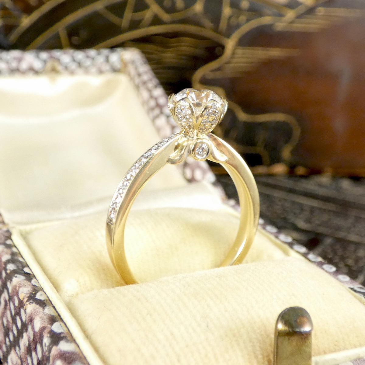 Gold ring with diamonds in a decorative box