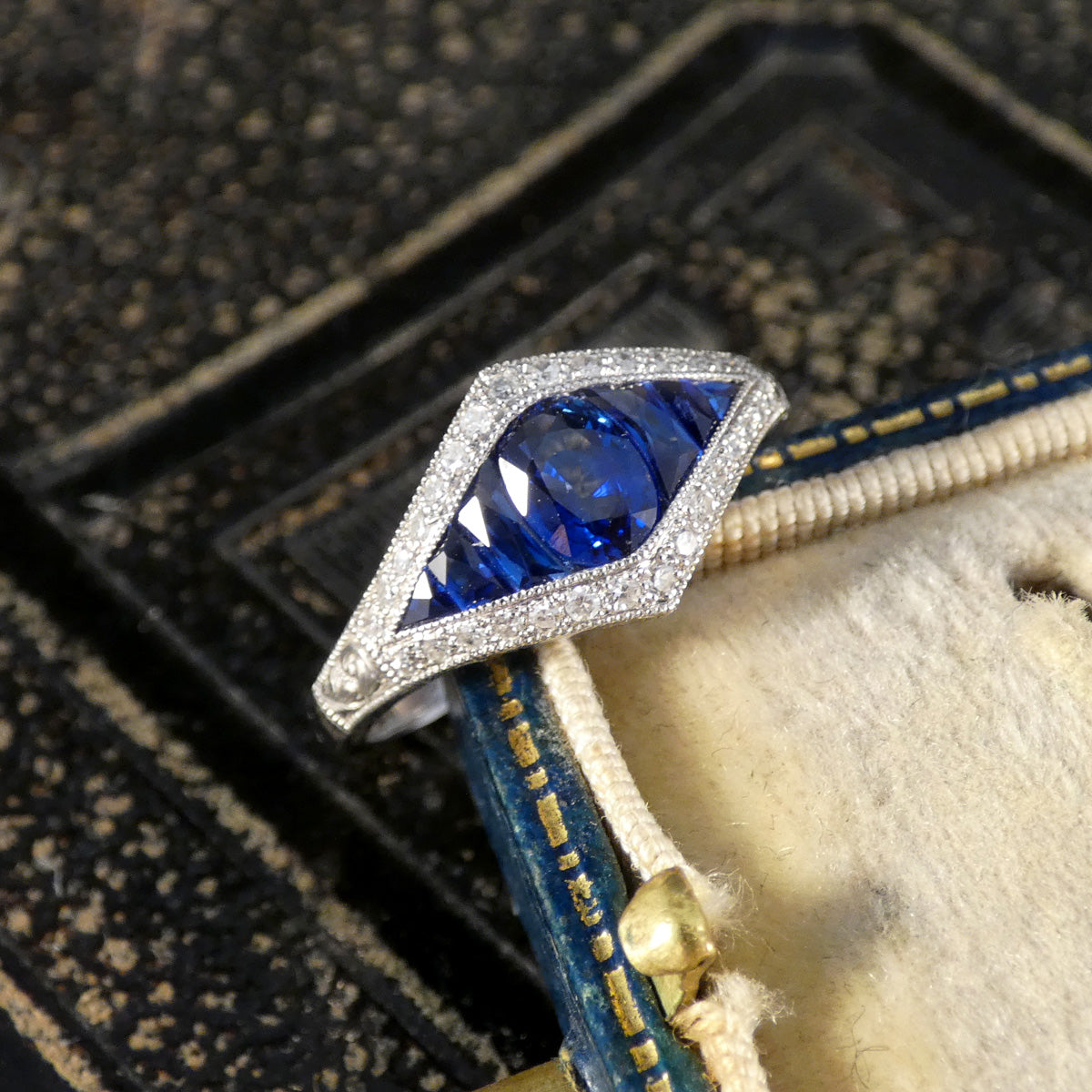 A gorgeous Art Deco style Sapphire and Diamond cluster ring in Platinum.