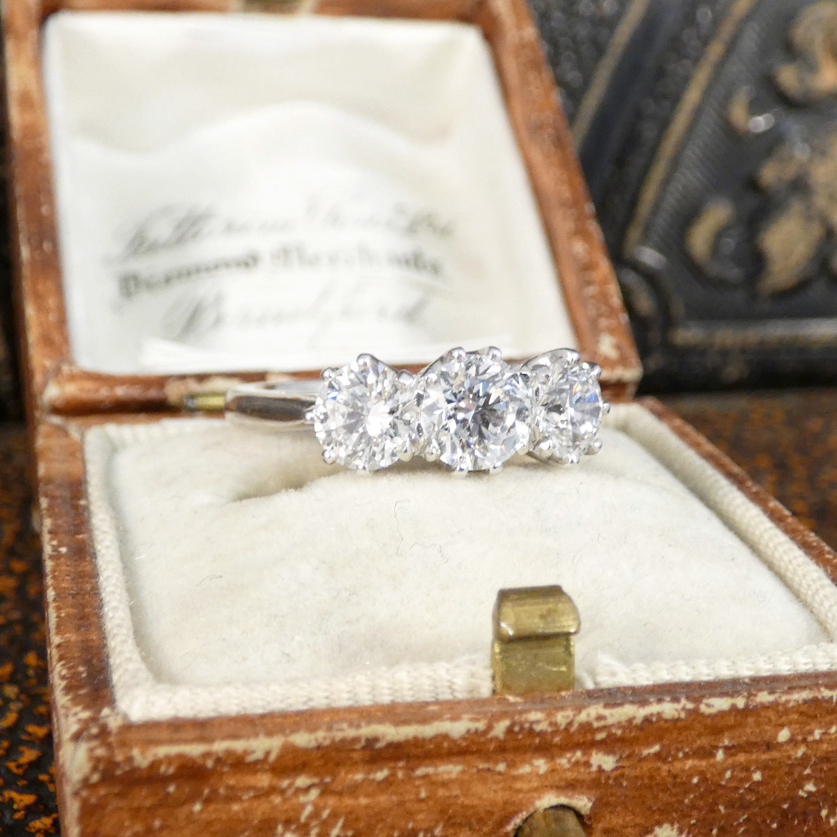 Diamond ring in an open wooden jewelry box