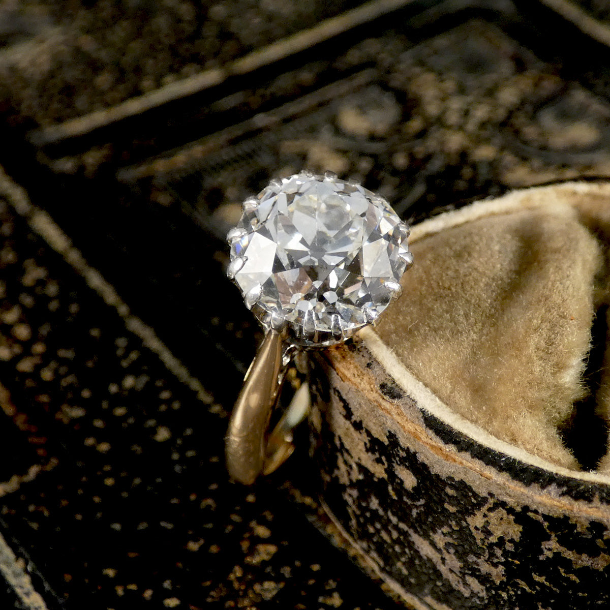 An Old Cushion shaped Mine cut diamond solitaire ring.