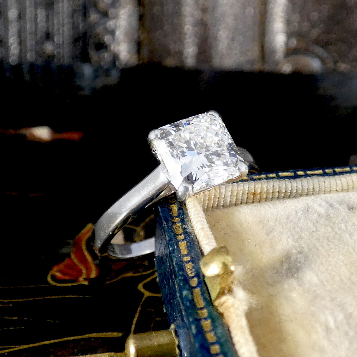 Diamond ring on a decorative box with a blurred background
