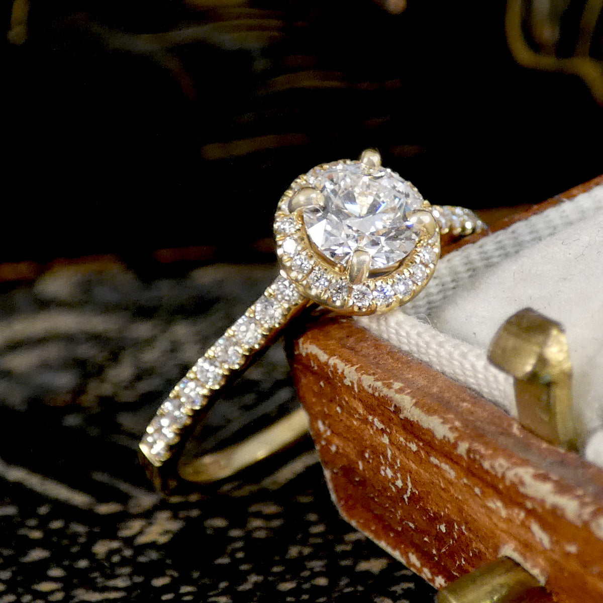GIA Cert D Colour Diamond Halo Cluster Engagement Ring with Diamond Shoulders in 18ct Yellow Gold. Close up to see the centre 0.50ct Diamond set in claws with a beautiful halo surround.