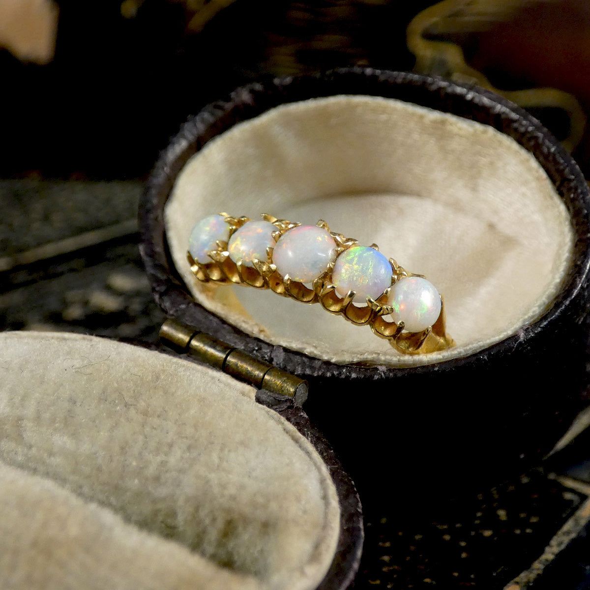 Gold ring with opal stones in a jewelry box