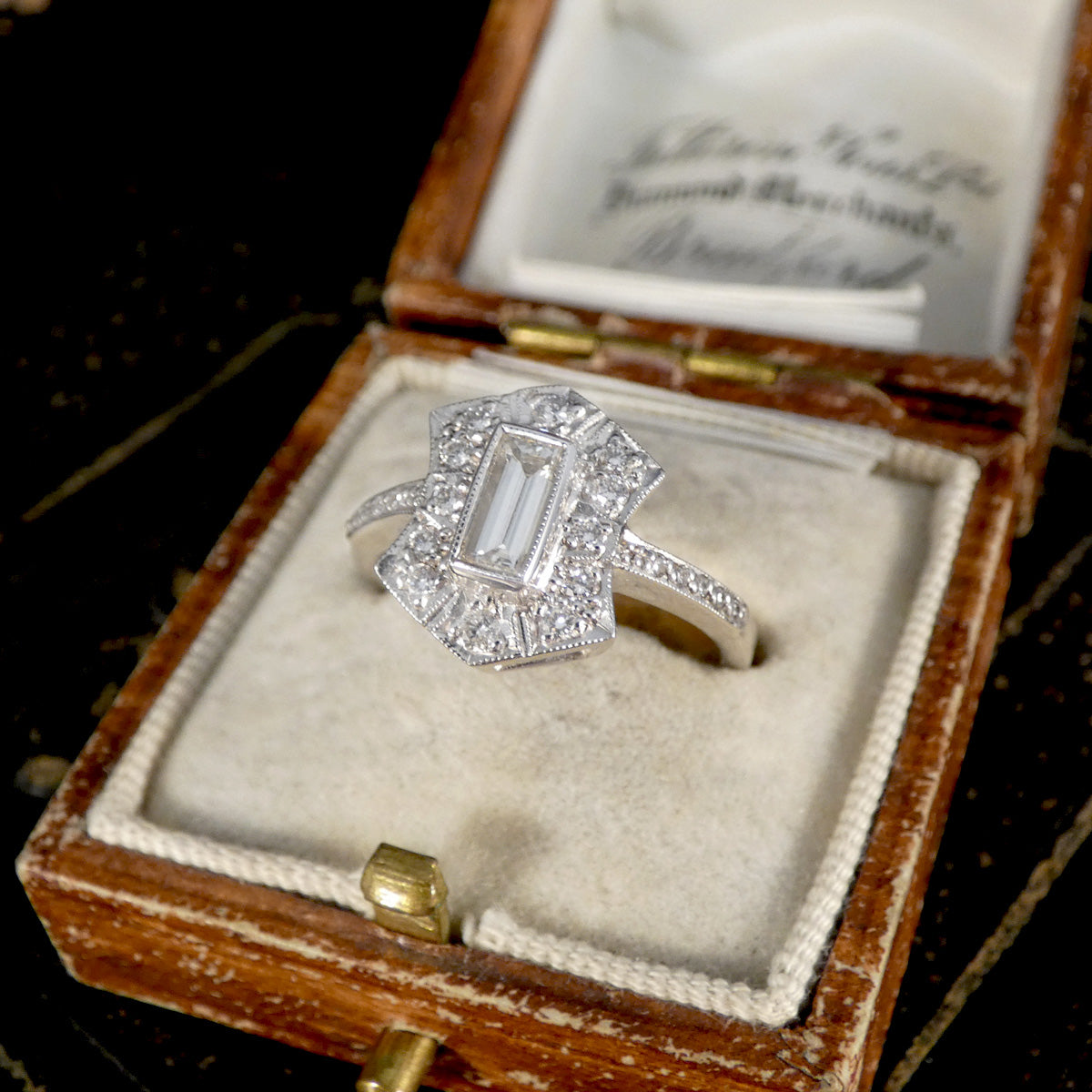 Diamond ring in a wooden box with a velvet interior