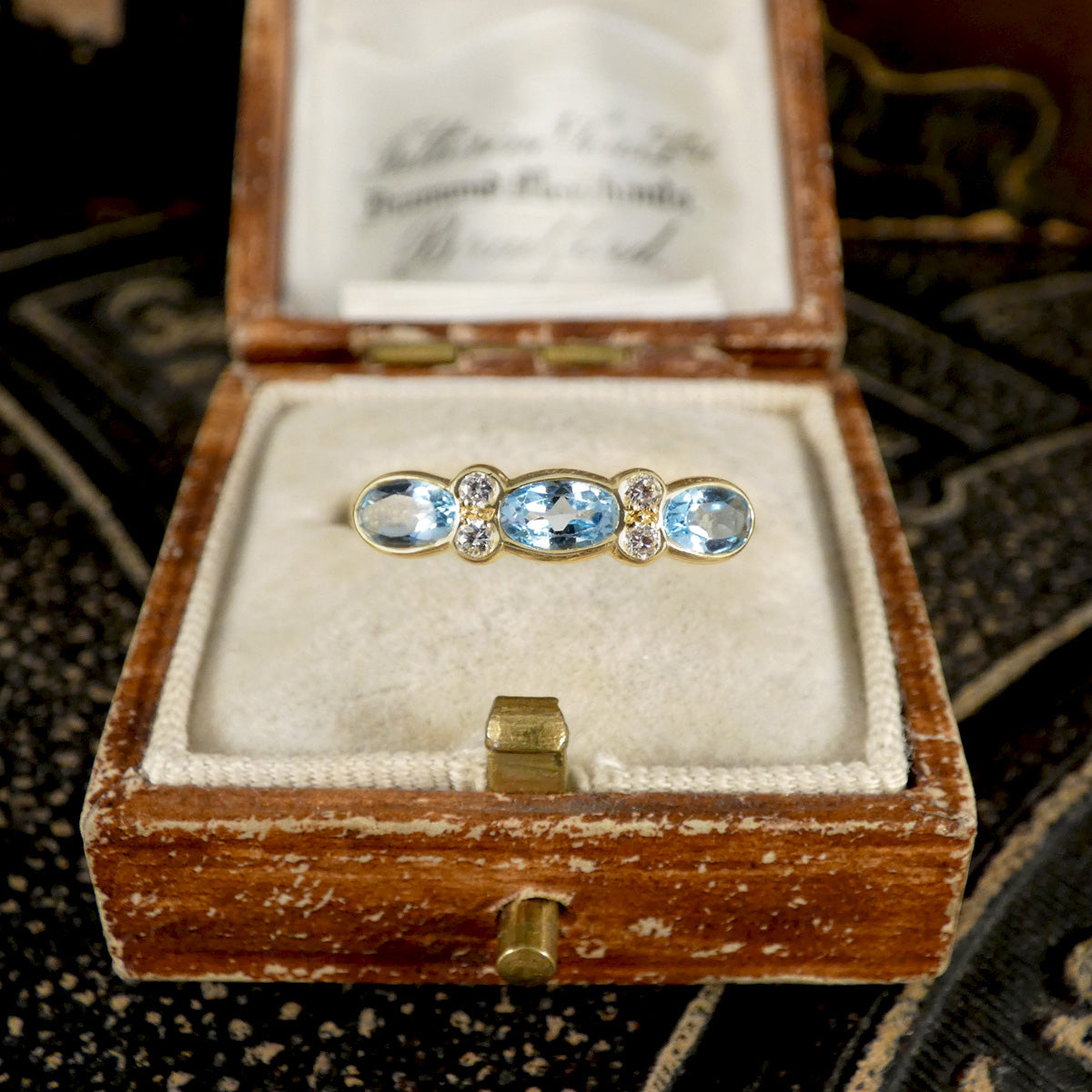 Blue Topaz and Diamonds ring in Yellow Gold shown in jewellery box