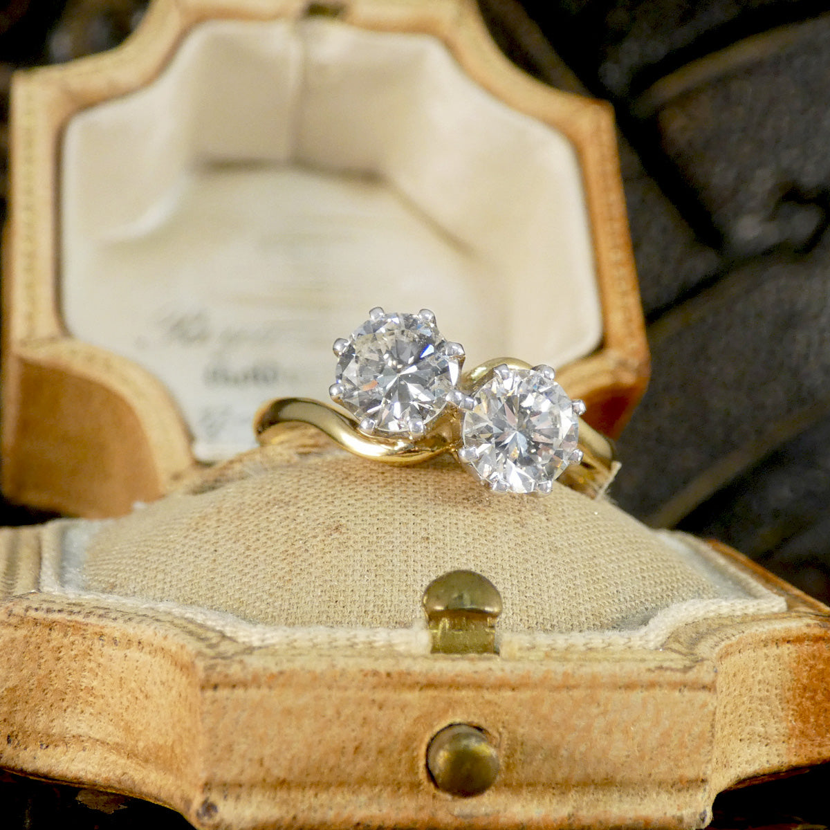 Gold ring with two diamonds in a vintage jewelry box