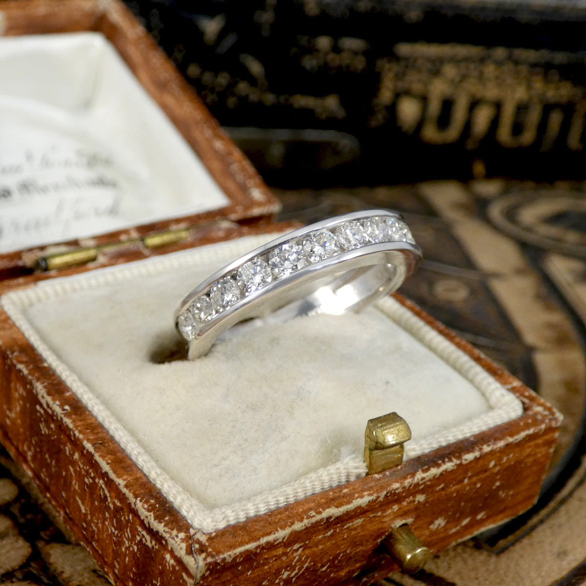 Silver ring with diamonds in a wooden box