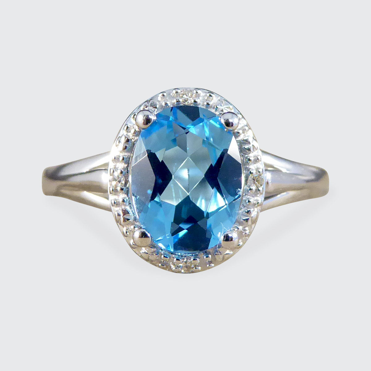 Oval Blue Topaz and Diamond Illusion Halo Cluster Ring in White Gold - Wharfedale Antiques