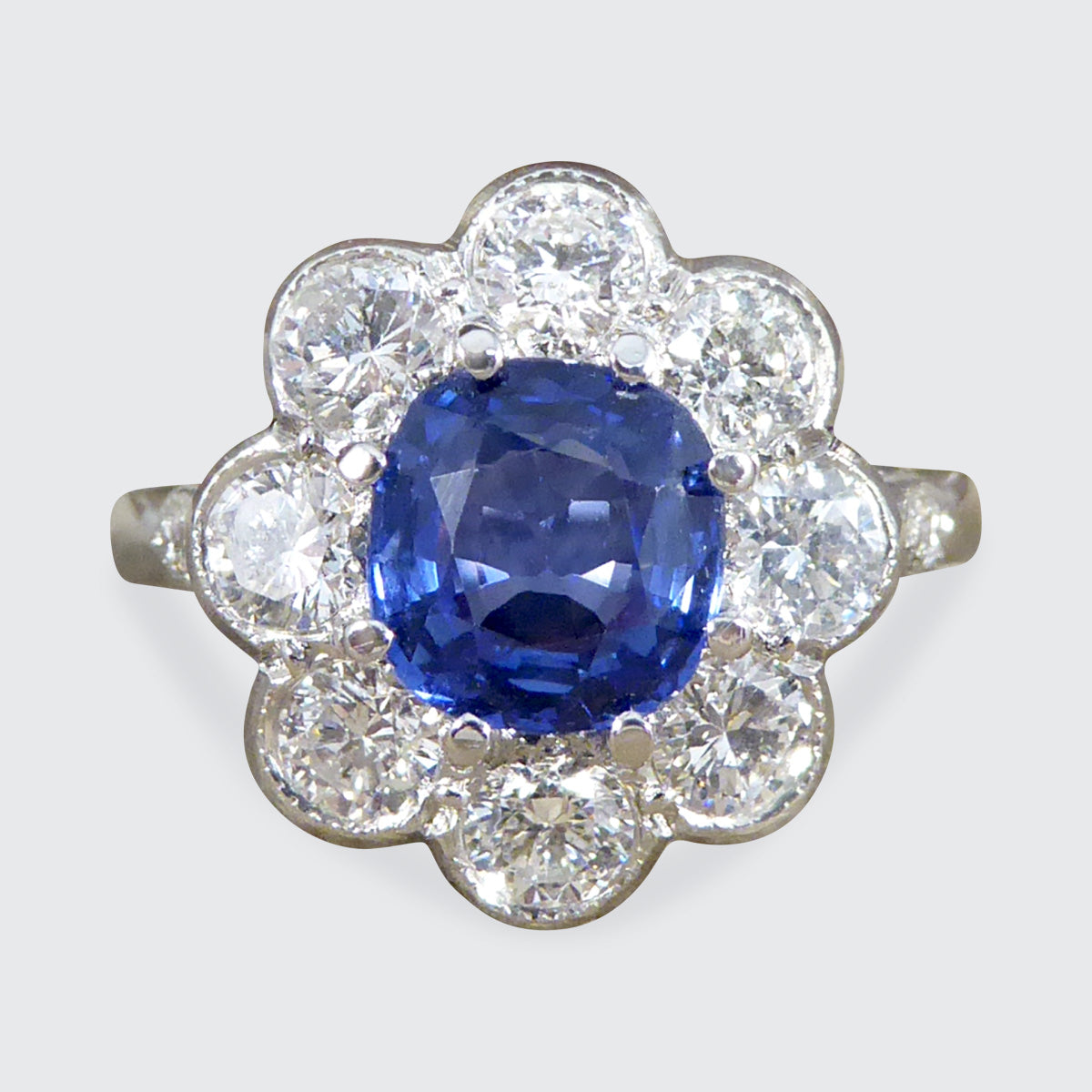 Contemporary Edwardian Style 1.50ct Sapphire and 1.10ct Diamond Cluster Ring in Platinum - Wharfedale Antiques