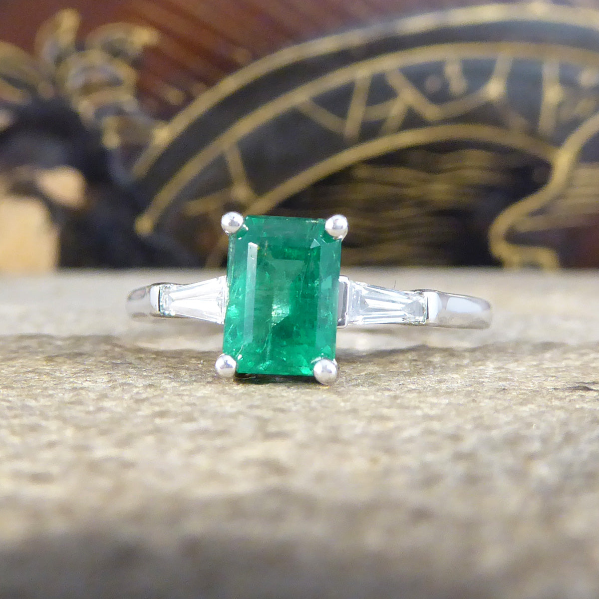 1.03ct Emerald Cut Emerald Ring with Tapered Baguette Cut Diamond Shoulders in Platinum - Wharfedale Antiques