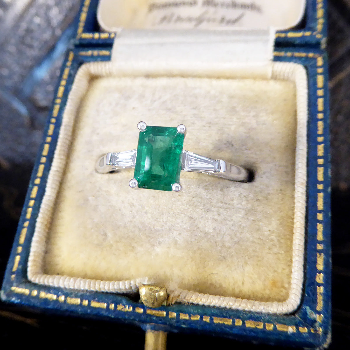 1.03ct Emerald Cut Emerald Ring with Tapered Baguette Cut Diamond Shoulders in Platinum - Wharfedale Antiques