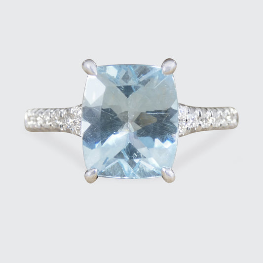 Ring with a blue gemstone and silver setting on a light gray background