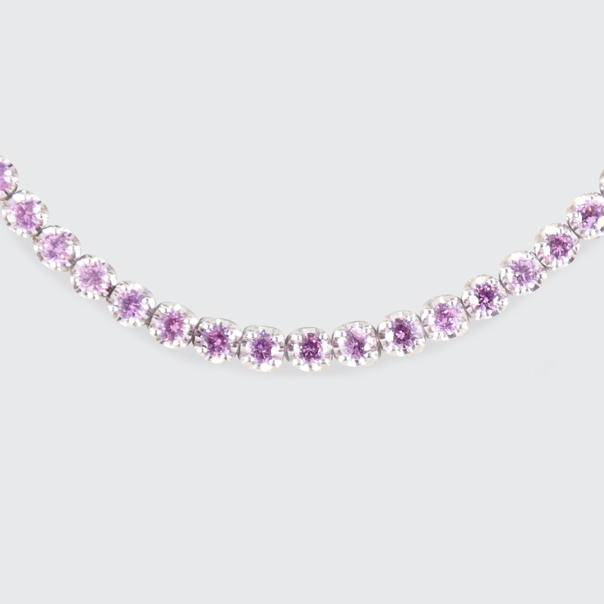 A pink sapphire and diamond tennis bracelet in white gold