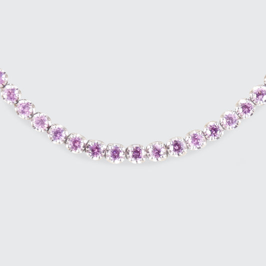A pink sapphire and diamond tennis bracelet in white gold