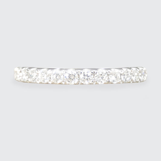 Diamond-studded bar ring on a light gray background