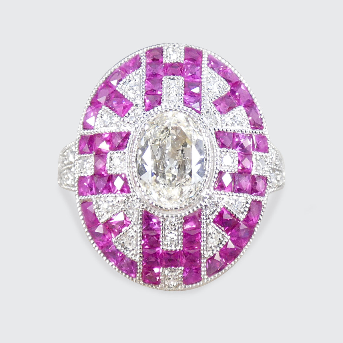 Art Deco Inspired Oval Cut Diamond Cluster Ring with Calibre Cut Rubies in Platinum