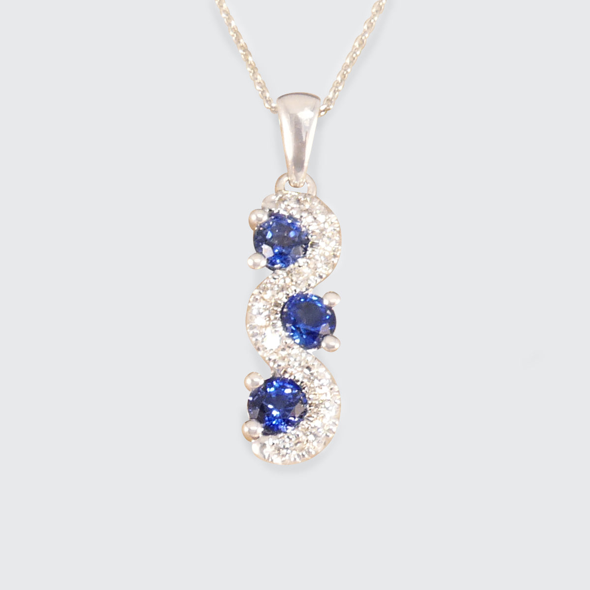 Ceylon Sapphire and Diamond Three Stone Lazy River Drop Pendant Necklace in Platinum - Wharfedale Antiques