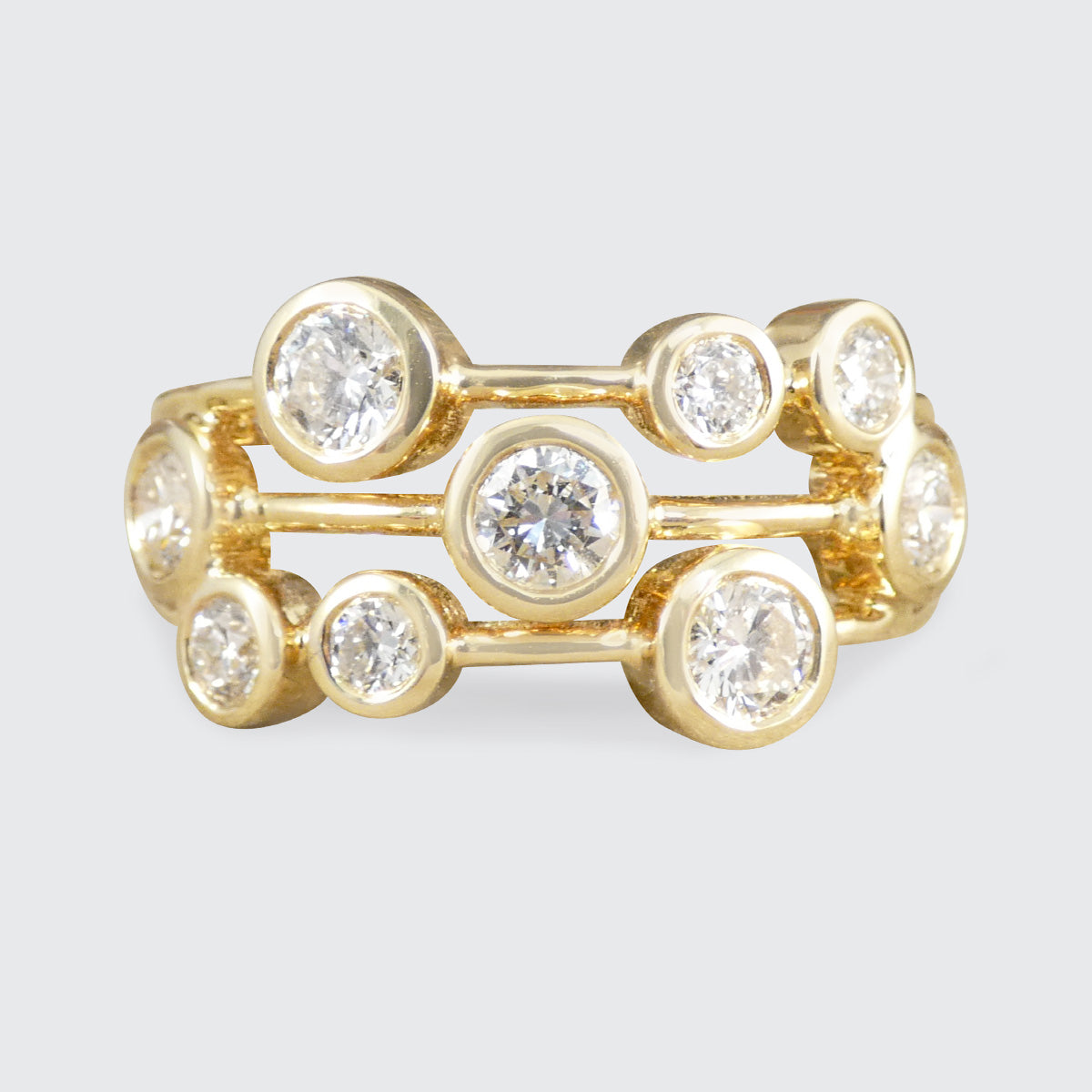 Gold ring with diamonds on a light gray background
