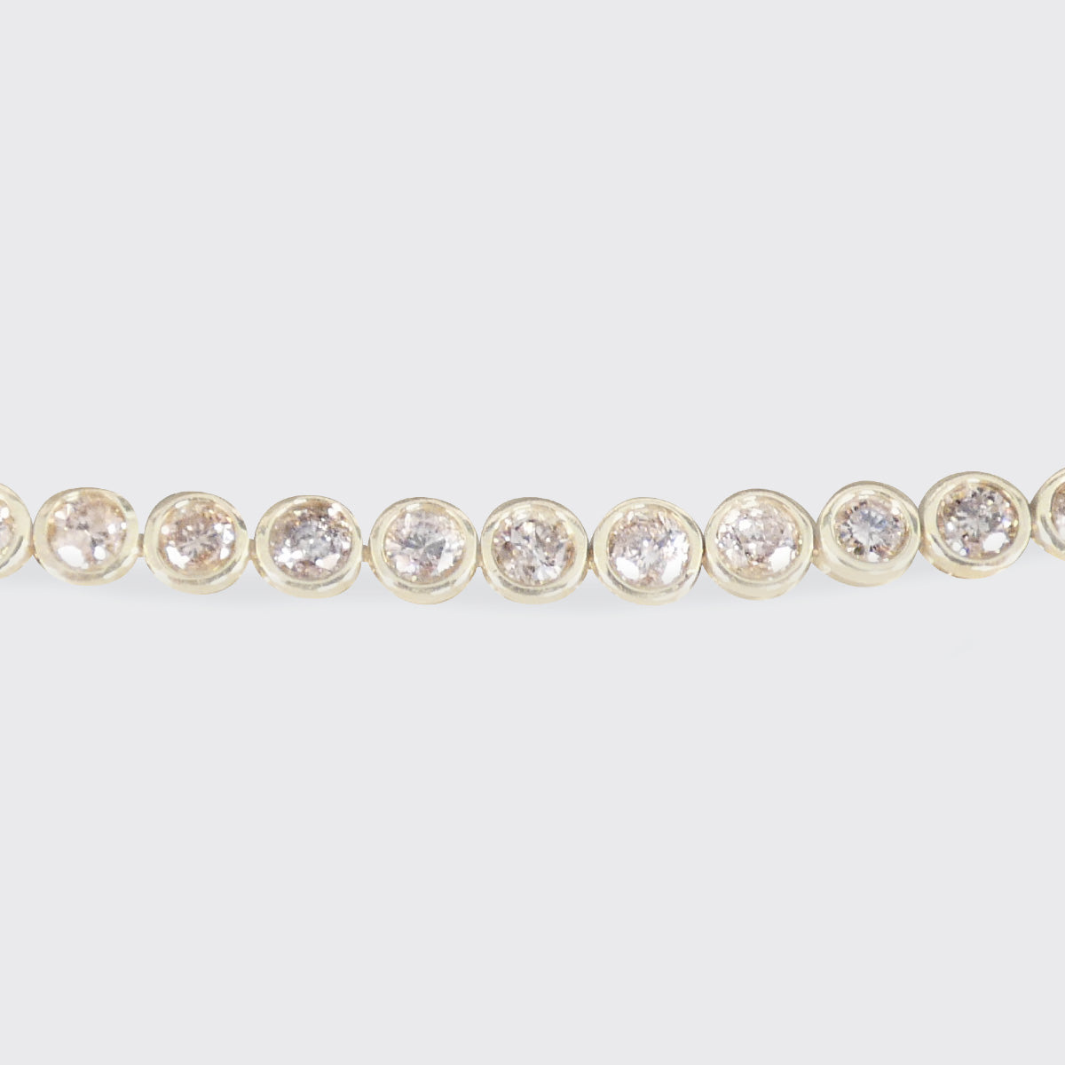 A champagne diamond tennis bracelet in 9ct yellow gold.