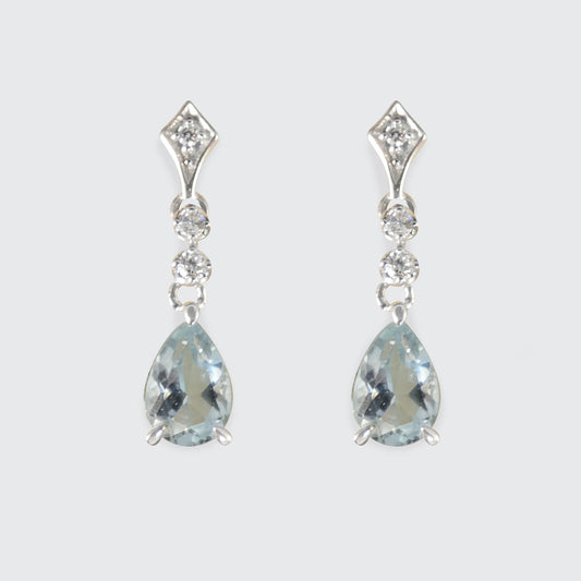 Pair of teardrop-shaped gemstone earrings with silver accents on a light gray background