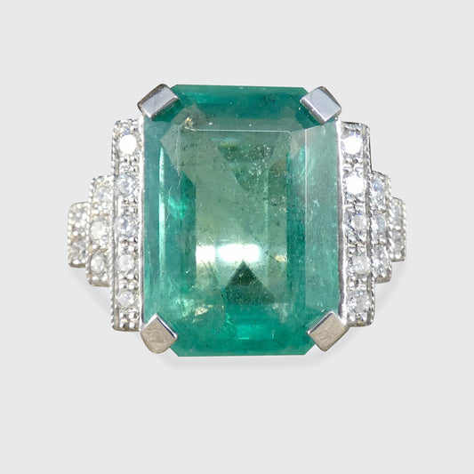 A gorgeous big and bright Emerald Cut Emerald and Diamond Dress Ring.