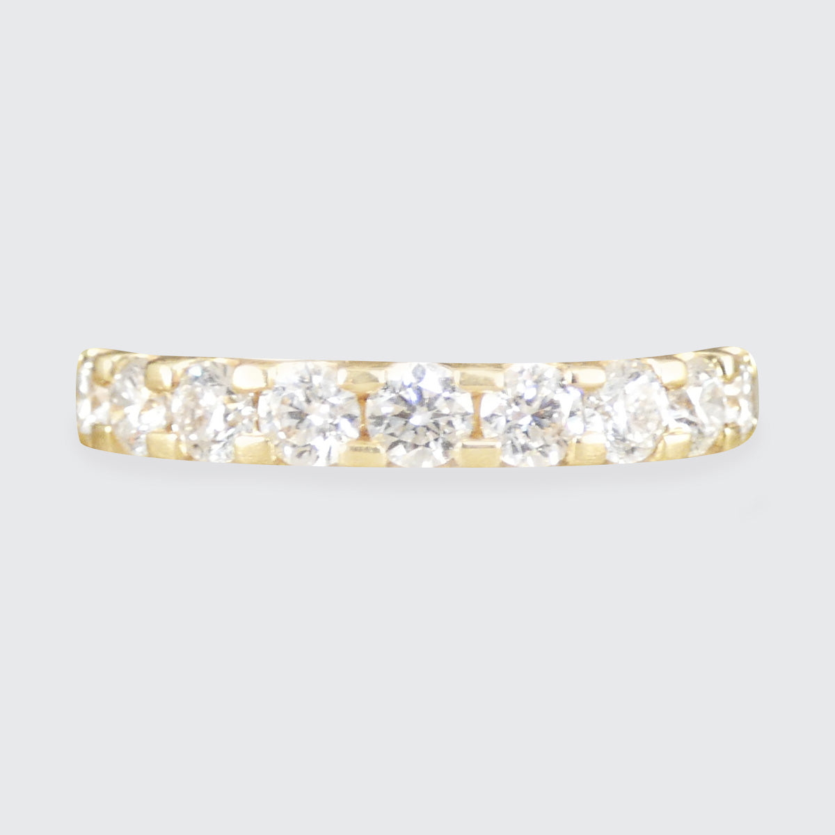 A diamond set half eternity ring in yellow gold
