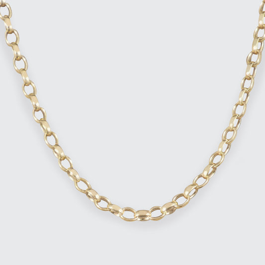 A close-up of a gold chain necklace with elongated oval links, shown against a light gray background.