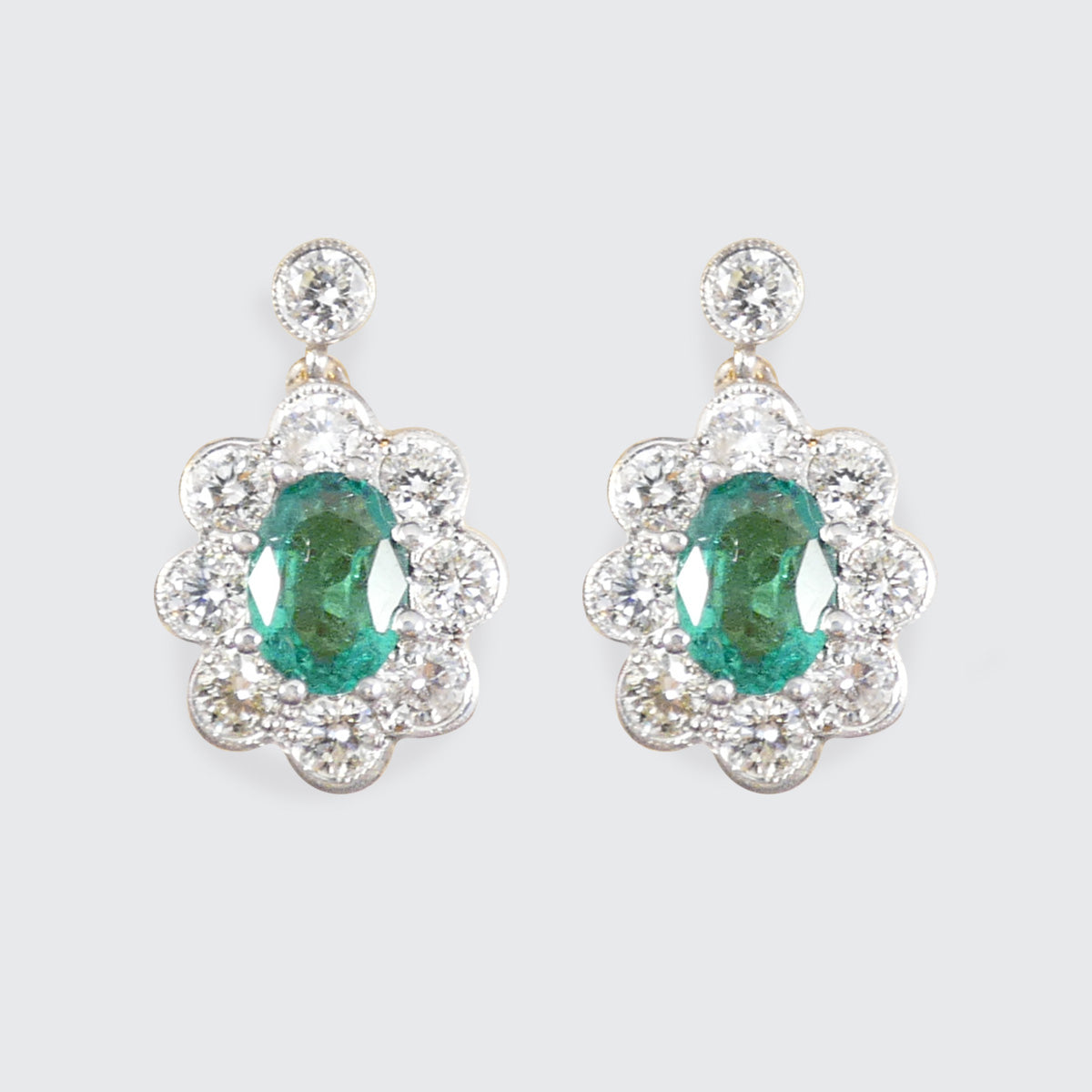 Emerald and Diamond cluster drop earrings in 18ct yellow and white gold.