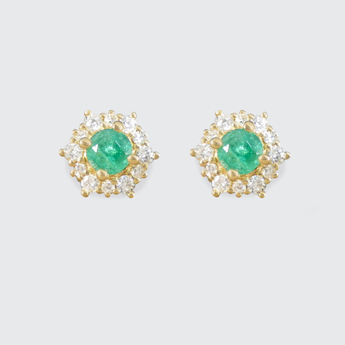Emerald and Diamond flower cluster stud earrings on a plain white background
