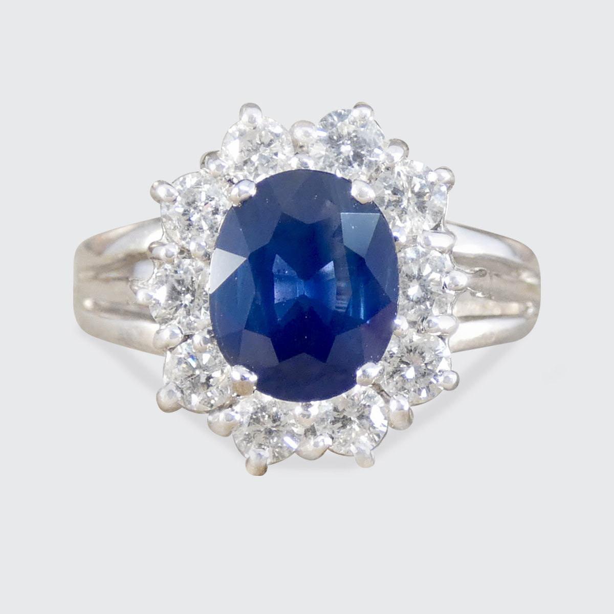 a Sapphire and diamond cluster ring in 18ct white gold