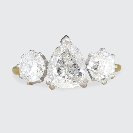 Diamond earring with three salt and pepper diamond pear-shaped diamonds on a light gray background
