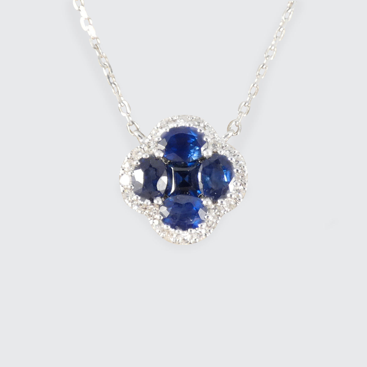 A sapphire and diamond cluster clover necklace