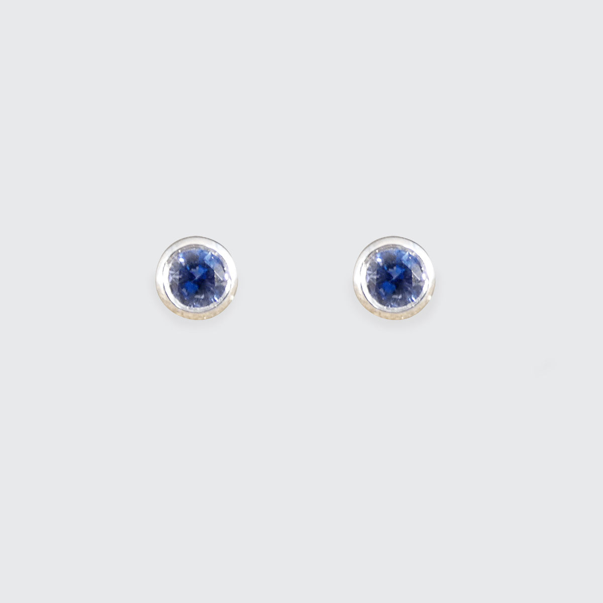 A pair of blue sapphire stud earrings in white gold.