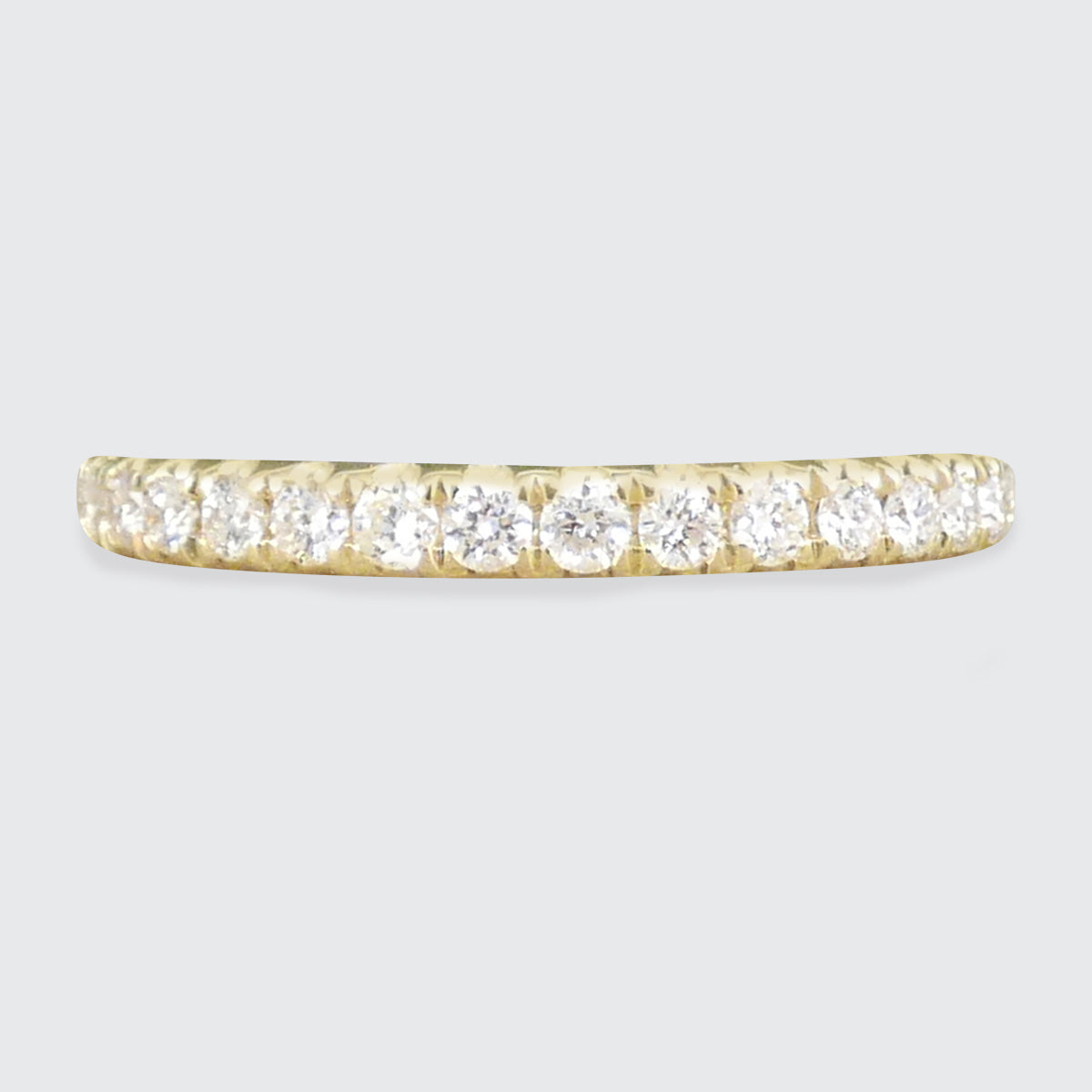 A diamond half eternity ring in yellow gold.