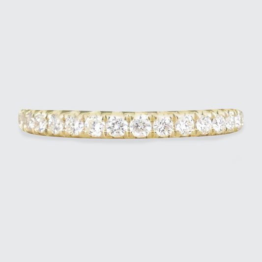 A diamond half eternity ring in yellow gold.