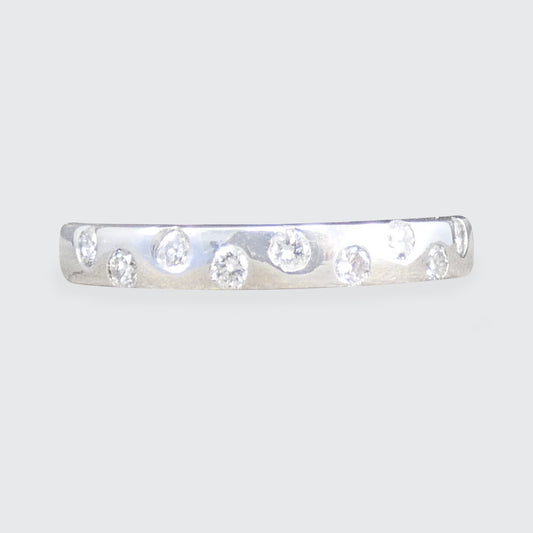 An alternate diamond half eternity ring in white.