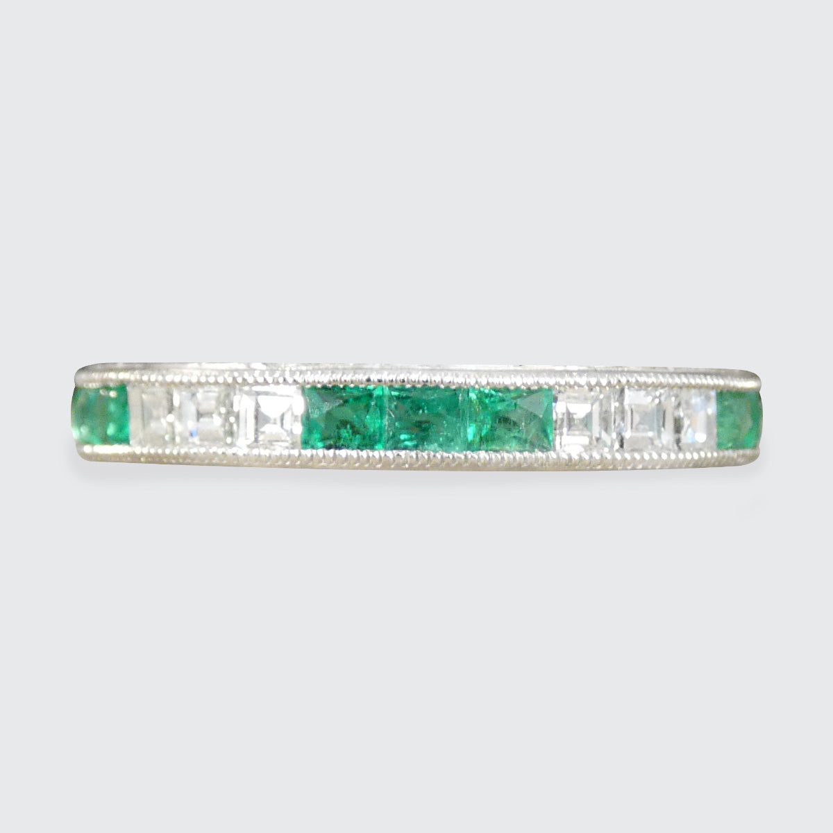 Art Deco Inspired Emerald and Diamond Full Eternity Ring in Platinum.
