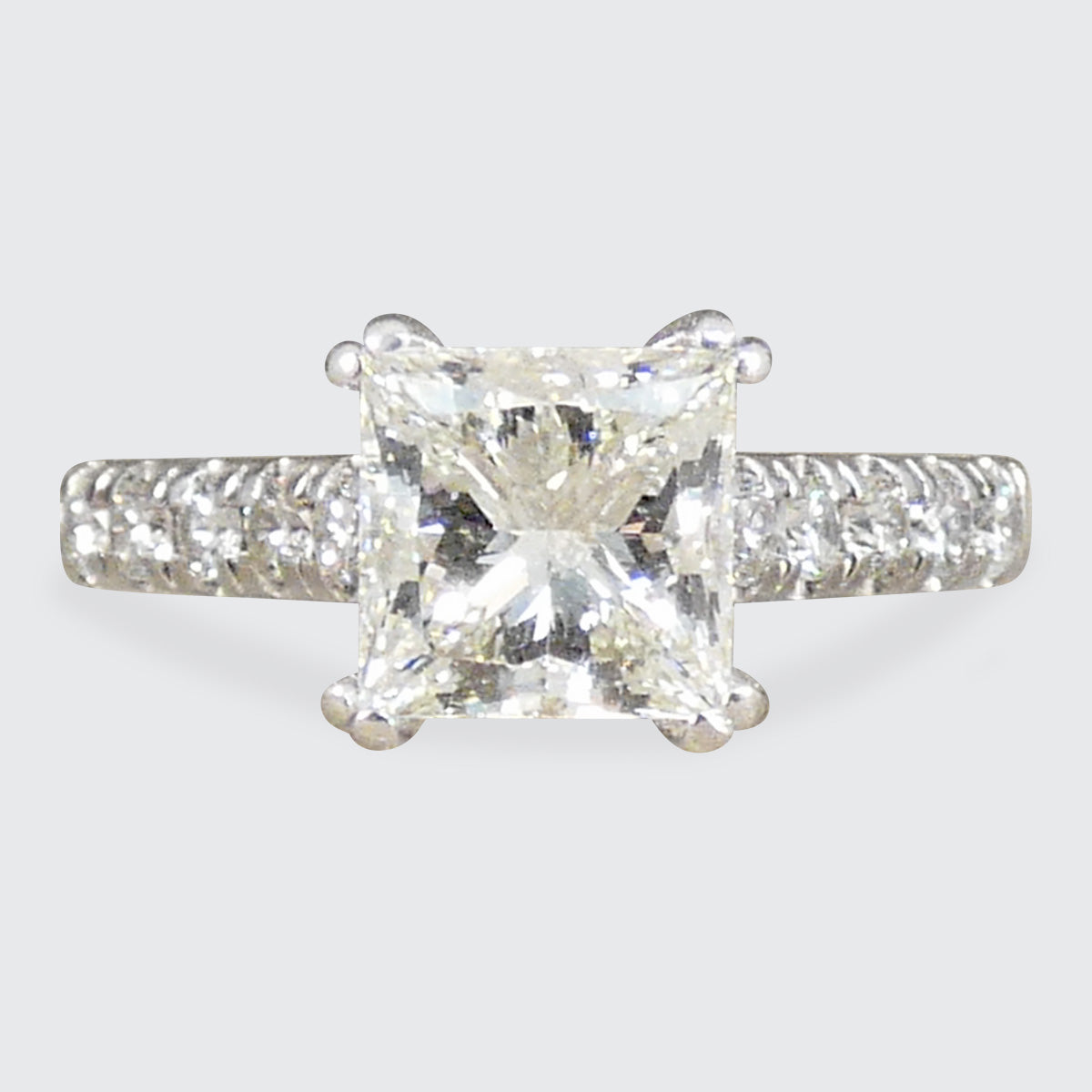 A gorgeous Princess cut Diamond Solitaire ring with diamond set shoulders in 18ct White Gold, the perfect engagement ring.