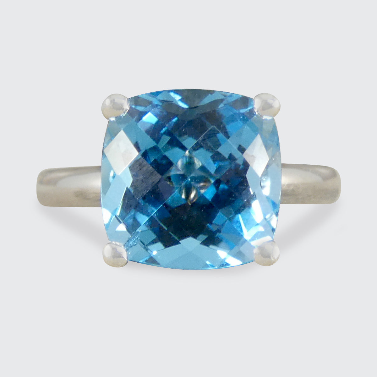 Ring with a blue gemstone on a white background