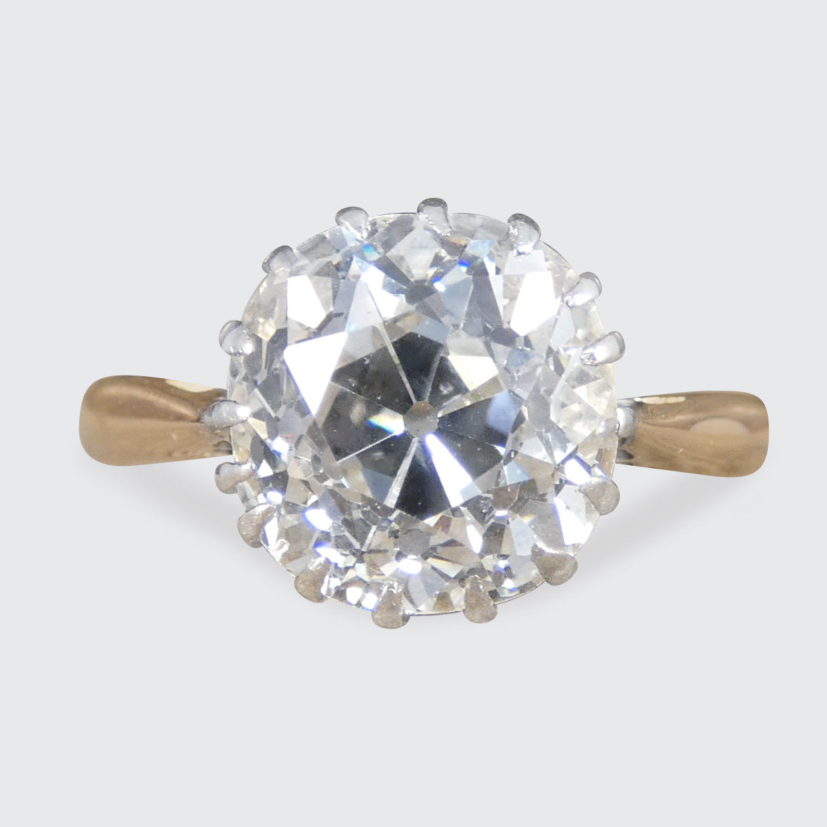 An old mine cut diamond solitaire in Gold