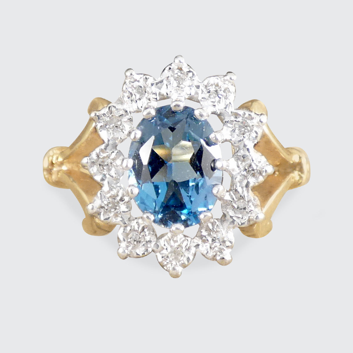 A blue topaz and diamond cluster ring in gold